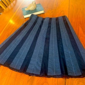 Gray Placated skirt with stitching detail.